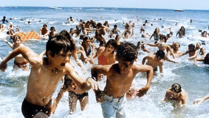 image from Jaws showing people running scared out of the sea