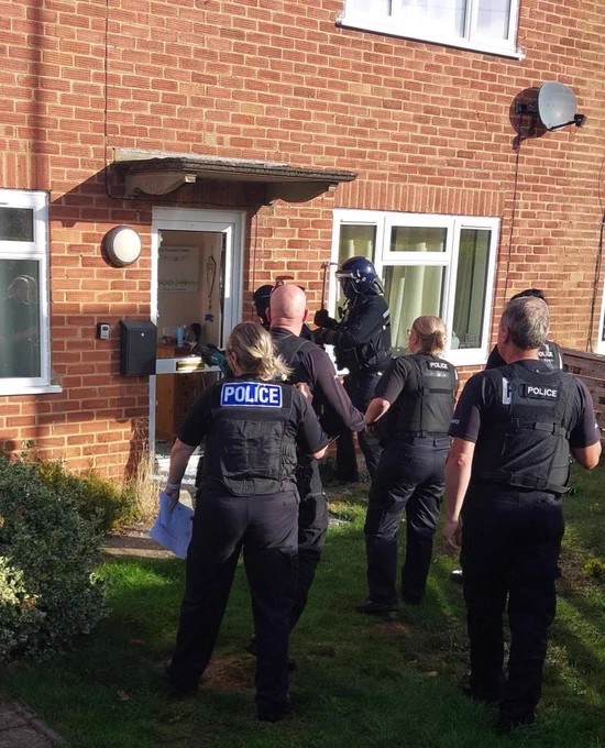 Officer's forcing entry through a front door.