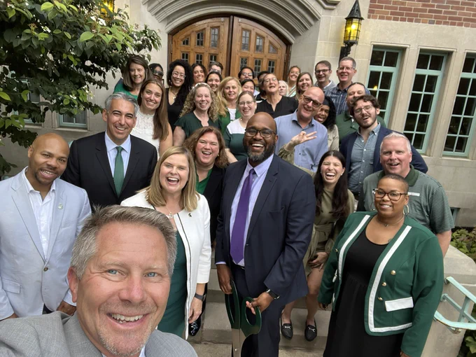 President Guskiewicz taking selfie with group of people at campbell hall ribbon cutting.
