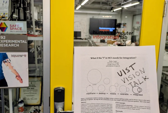 Door of my lab and me holding the printed talk