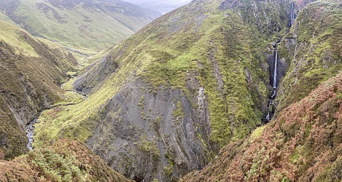 Zoomed out view of a waterfall at Dob’s Linn