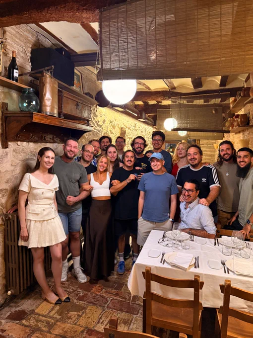 Group picture of a bunch of speakers and organisers standing in an rustic Spanish restaurant.
