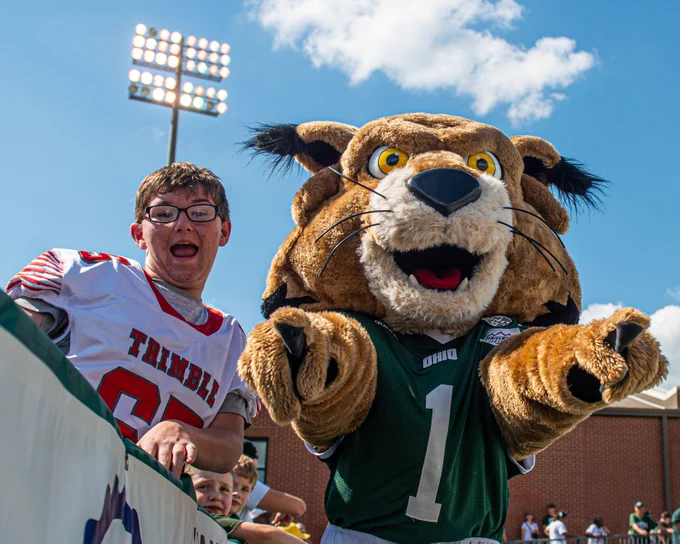 Rufus mascot an kid smile for camera.