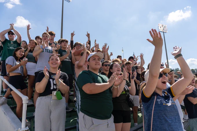 Fans cheering in stands.