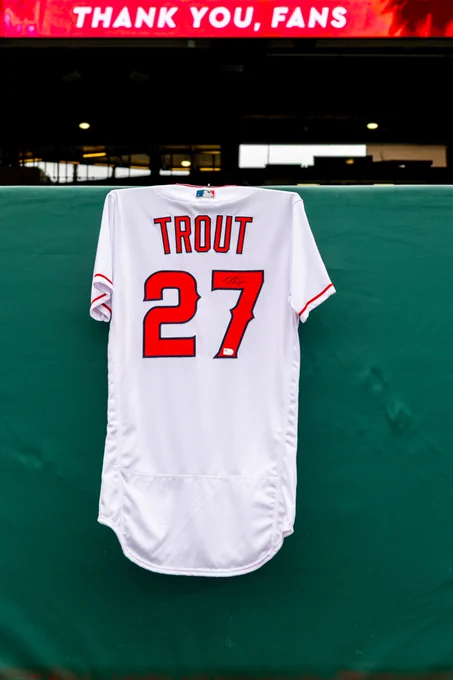 A Mike Trout jersey, which hangs on a wall at Angel Stadium under a thin video ribbon board that reads "Thank You, Fans," displays Trout's autograph on his number on the back of the jersey. 