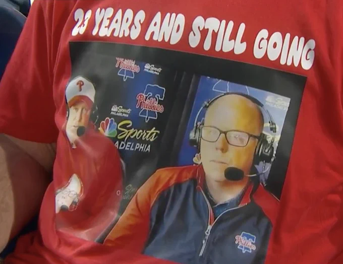 Photo of Kruk and TMac on a t-shirt that says "23 years and still going"