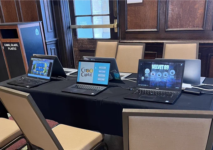 laptops on table with various games loaded