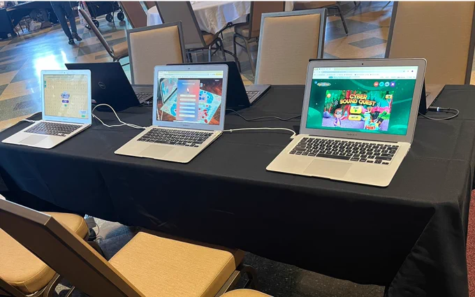 laptops on table with various games loaded