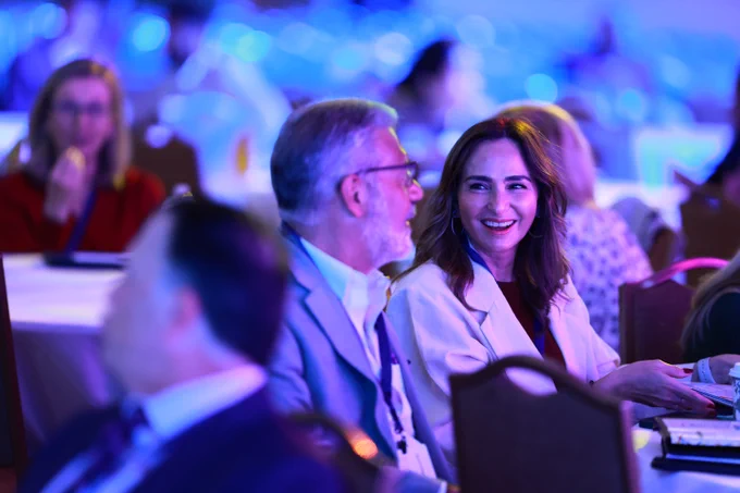 Zoomed in photo of man and woman in crowd at UNIFY 2025