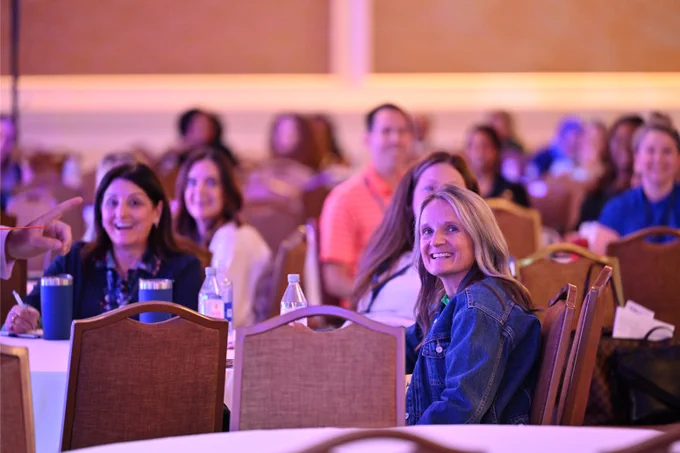 Happy smiling faces in crowd at UNIFY 2025