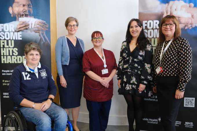 A group photo of attendees at the vaccine clinic. From left to right: Oliva Fulton - who received her flu vaccine today, Dr Claire Cameron - Consultant at Public Health Scotland, Laura Hall - Clinical Nurse Manager, NHS Lothian and Edinburgh HSCP,  Dr Nicola Steedman - DCMO, and Jill Irvine, NHS Lothian and Edinburgh HSCP. 