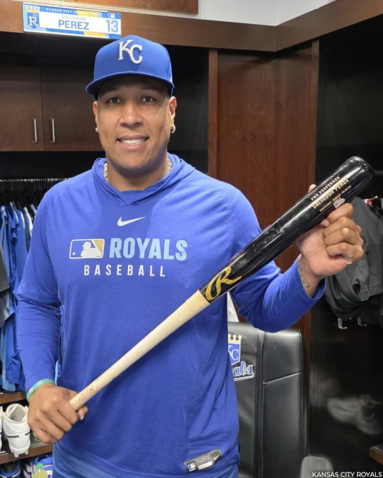 Salvador Perez stands at his clubhouse locker and holds the bat he used to hit his 300th career home run. (Photo courtesy Kansas City Royals)