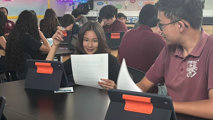middle schooler smiling as they read about their pen pal