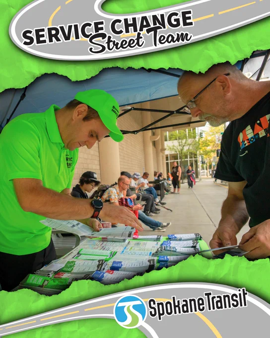 Spokane Transit Service Change Street Team member in a bright green shirt and hat helping a rider with route brochures at an outdoor information booth.
