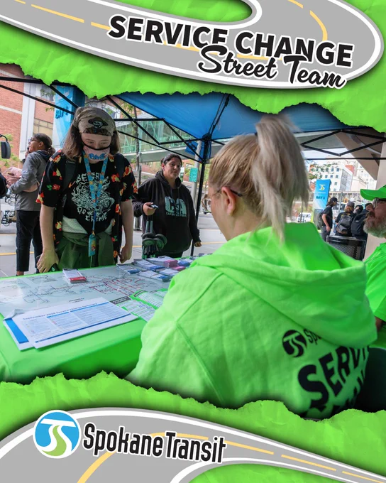 Spokane Transit Service Change Street Team members in bright green gear assist a rider at an outdoor booth with route maps and brochures.