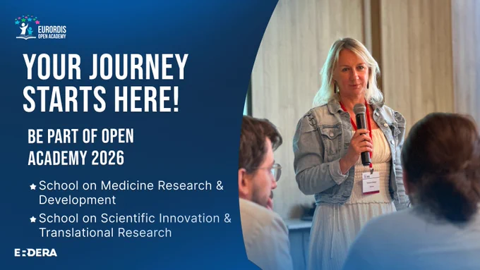 "Your journey starts here, be part of open academy 2026. School on medicine research & development. School on scientific innovation & translational research"
Woman in a denim jacket speaking into a microphone at a seminar with attendees listening attentively.