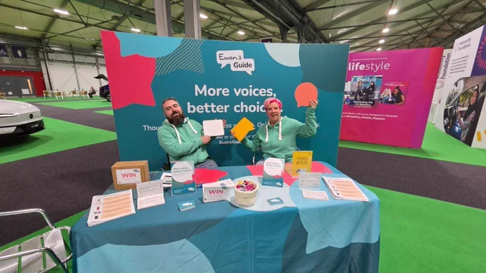A photo of Joe and Julie in front of the Euan's Guide exhibition stand 