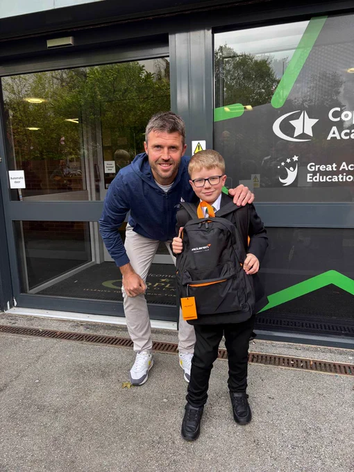 Michael Carrick and a pupil with their back-to-school pack.