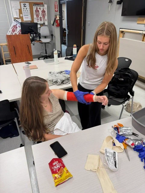 2 third year ot students practicing fitting and casting in lab