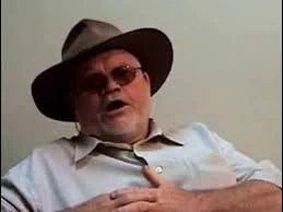 Professor Len Barton in his signature hat - saying something important as always 