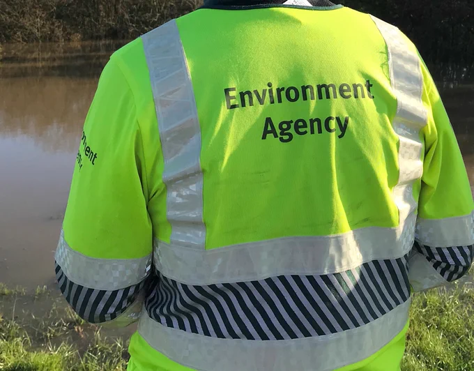 An Environment Agency Officer in High Vis jacket.