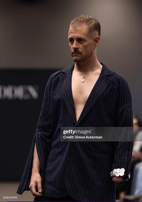 Paul “Stumpy” Davies, Welsh presenter on S4C’s Heno and disability & LGBTQ  advocate, modelling at London Fashion Week with Unhidden. The runway showcases adaptive, inclusive fashion by designer Victoria Jenkins, promoting accessibility, queer visibility, and Welsh representation on an international stage.