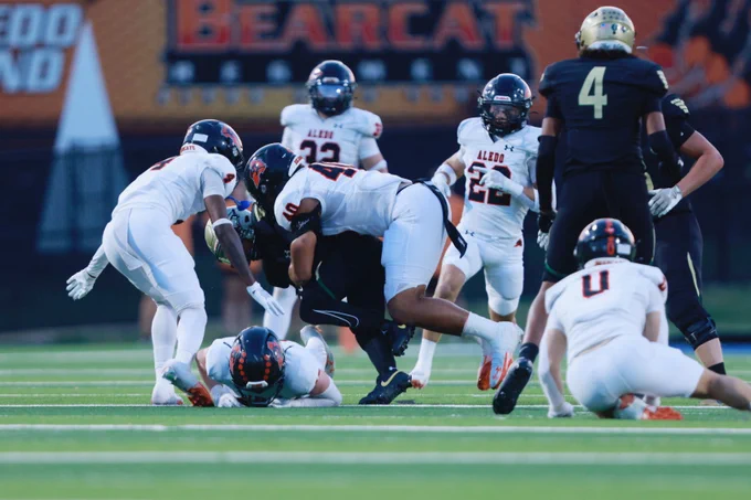 Participating in a gang tackle against Birdville are Alex Patton (4), JoJo Cooper (40), Chase WIlburn (32), Ryland Haley (22), Ashton Hebel (0) and one identified player.