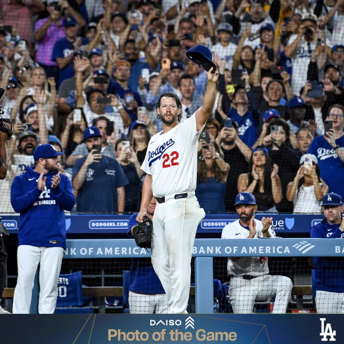 A photo of Clayton Kershaw raising his hat to the fans at Dodger Stadium.