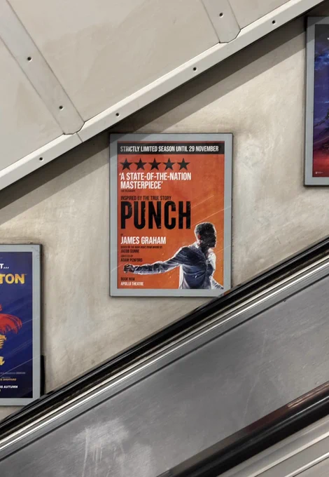 A poster advertising Punch above escalators on the tube