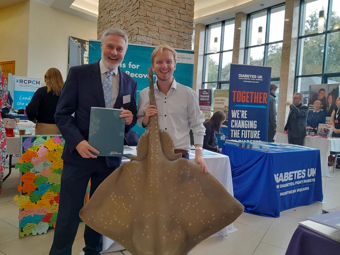 NIMTF Officer with Paul Frew MLA, with Officer holding a Flapper Skate prop. Discussions around offshore renewables and how these can be done alongside nature's recovery were had