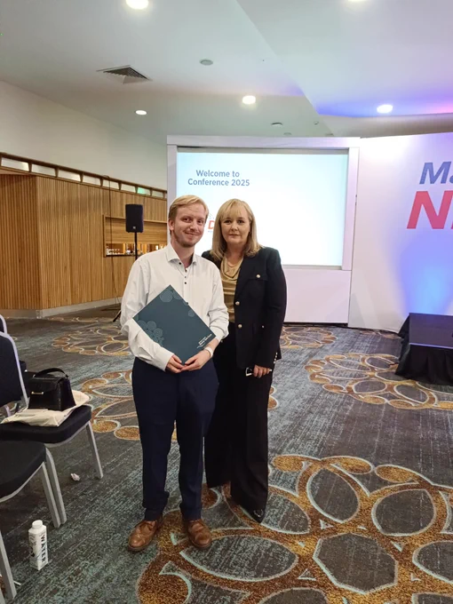 NIMTF Officer and Michelle McIlveen stood beside each other at the DUP Party Confefence