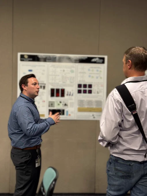 Nolan discussing his poster with his former mentor and U of Delaware professor - Chris Kloxin