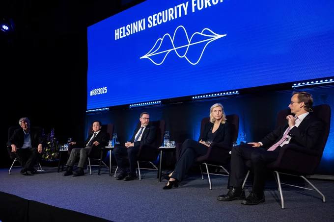 A panel discussion with 5 people on stage.