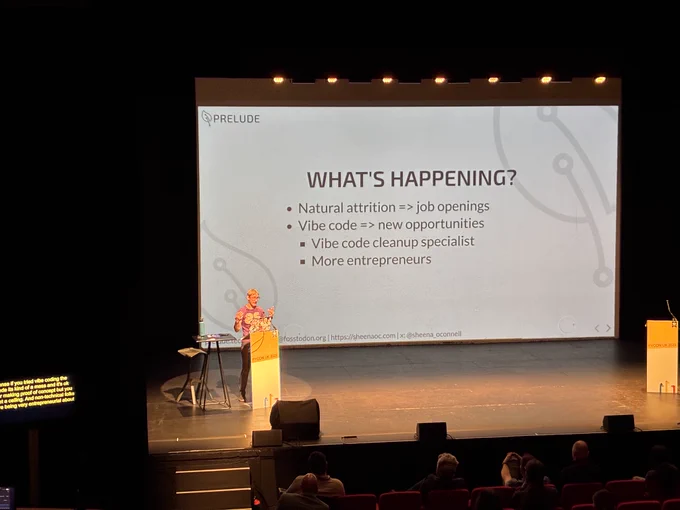 Sheena on stage introducing us all to the new vibe coding cleanup specialist job role