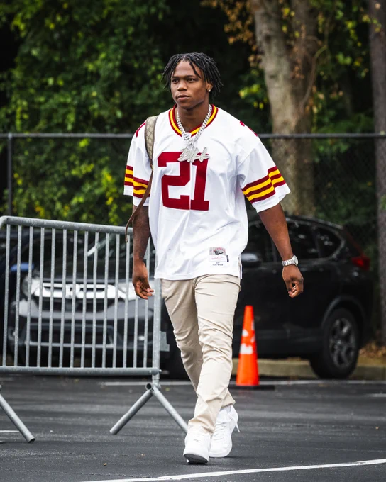 Photo of Bill Croskey-Merritt in the parking lot arriving at Northwest Stadium. He is wearing a Sean Taylor jersey.