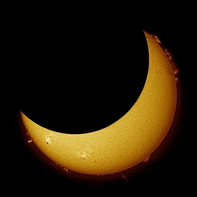Partial solar eclipse, 70% of the left top of the sun is covered by the moon 
