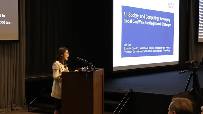 Meeyoung Cha, opening keynote speaker, at the podium.