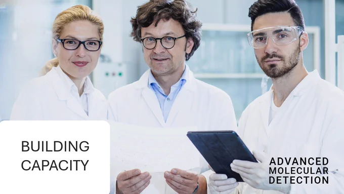 Three public health scientists set up samples on sequencing instruments “building capacity” and “advanced molecular detection.”