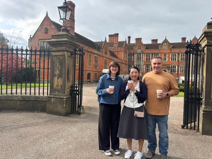 Dr Nao Yamamoto, Alex Rollinson, and Professor Paul Revill enjoying a coffee break in front of Heslington Hall at the University of York