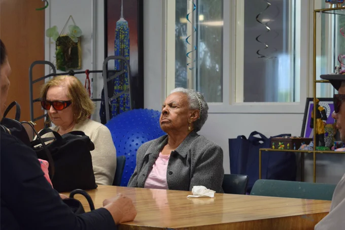 A senior participant at Miami Lighthouse for the Blind meditates during a group session.