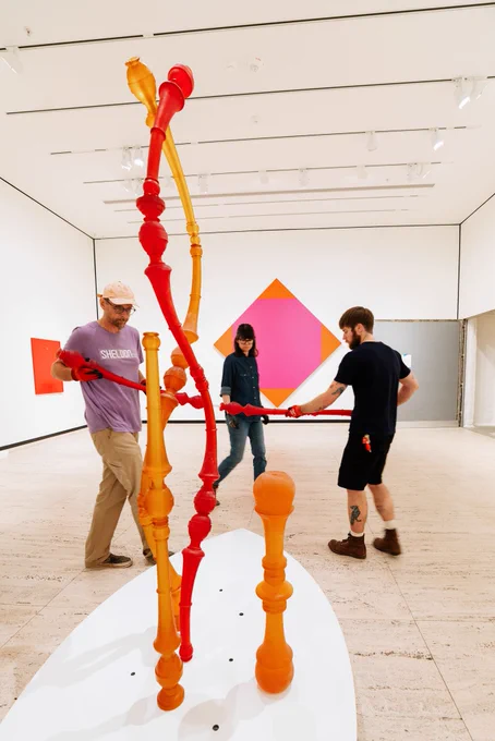 Sheldon Museum of Art staff helping assemble showpieces for the Go Big Red exhibit. 