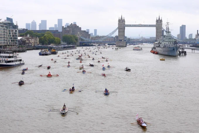 A photo of The Thames with lots of rowing boats on it