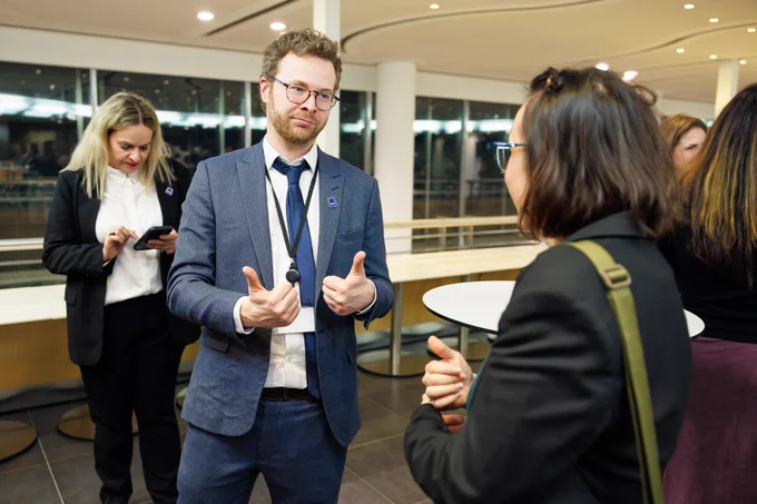 Two people talk during a reception