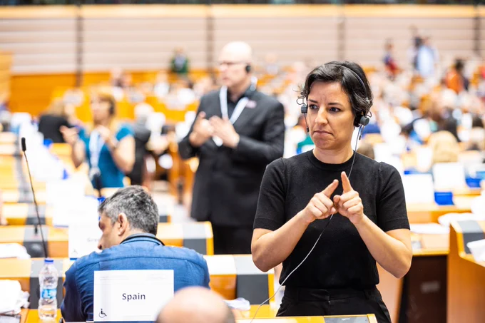 A sign interpreter translates during a meeting