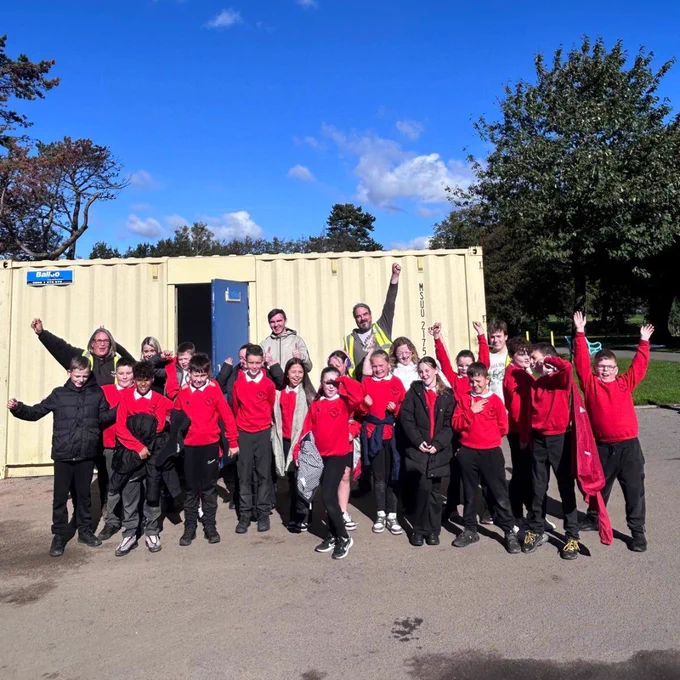 Image shows school pupils with the team from the Community Archaeology Programme NI (CAPNI).