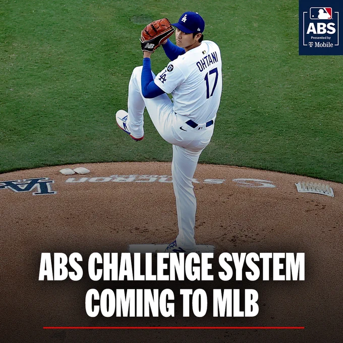 Shohei Ohtani pitching on the mound at Dodger Stadium. He's wearing his Dodgers home white uniform.
Text reads: ABS CHALLENGE SYSTEM COMING TO MLB