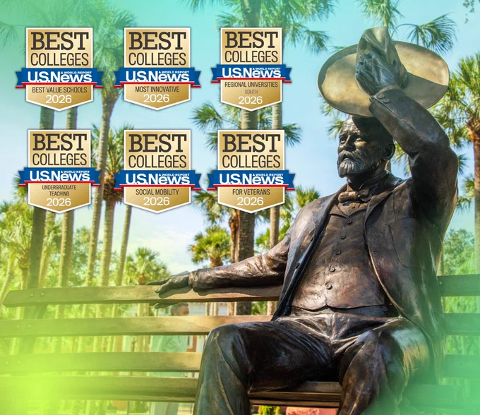 A statue of John B. Stetson is surrounded by multiple "U.S. News Best Colleges 2026" award plaques, set against a backdrop of palm trees and clear blue sky.