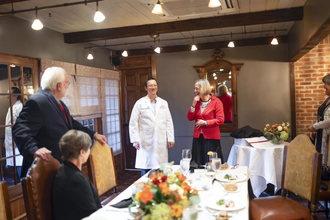 Dr. Tamyia wearing new white coat next to Dr. Carol Bradford