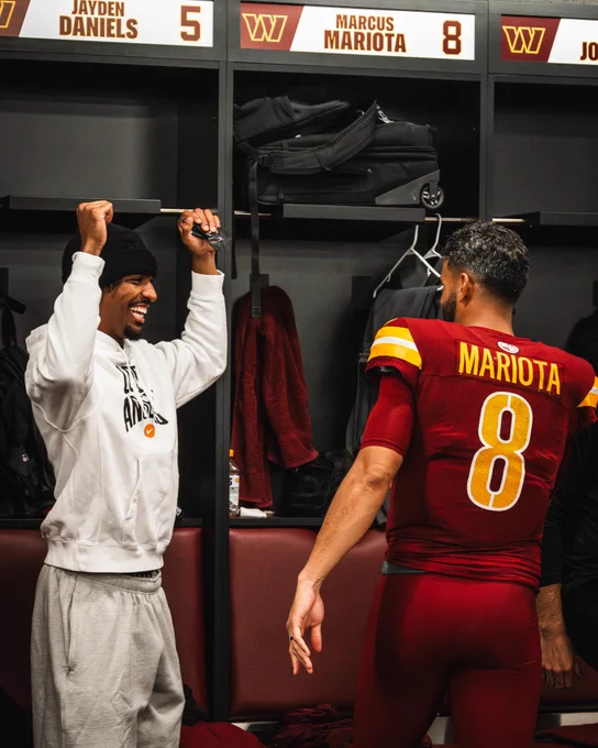 Photo of Jayden Daniels and Marcus Mariota celebrating in the locker room postgame.