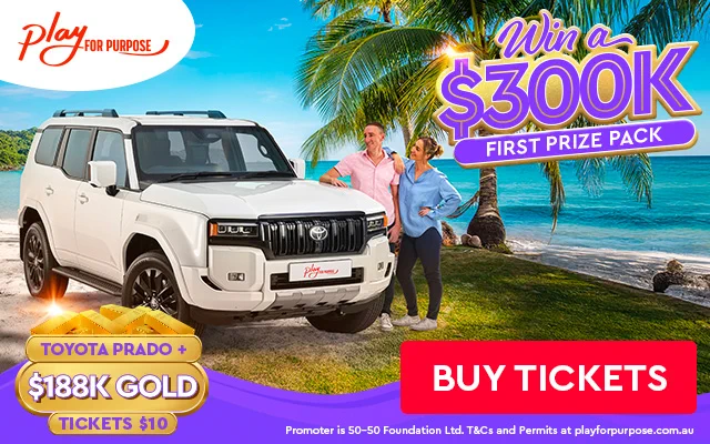 Toyota Prado with a couple next to it parked next to the beach.
